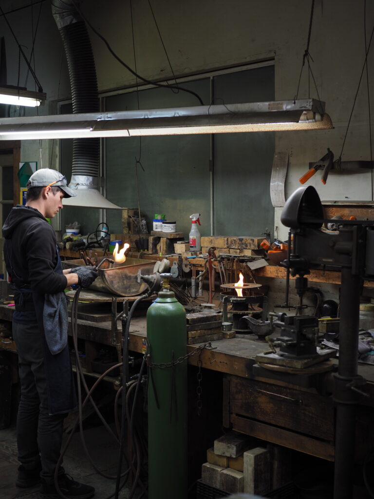 Alecsander working in the shop